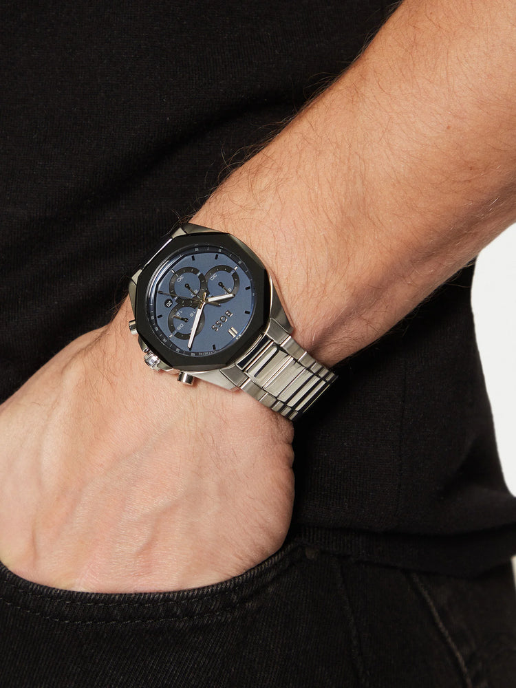 Close-up of a person's wrist wearing a silver watch with a blue face. maroc